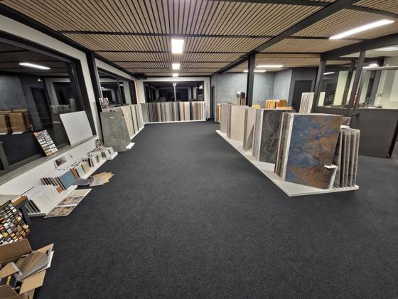 Corridoio dello showroom con espositori di grandi lastre in gres su entrambi i lati
